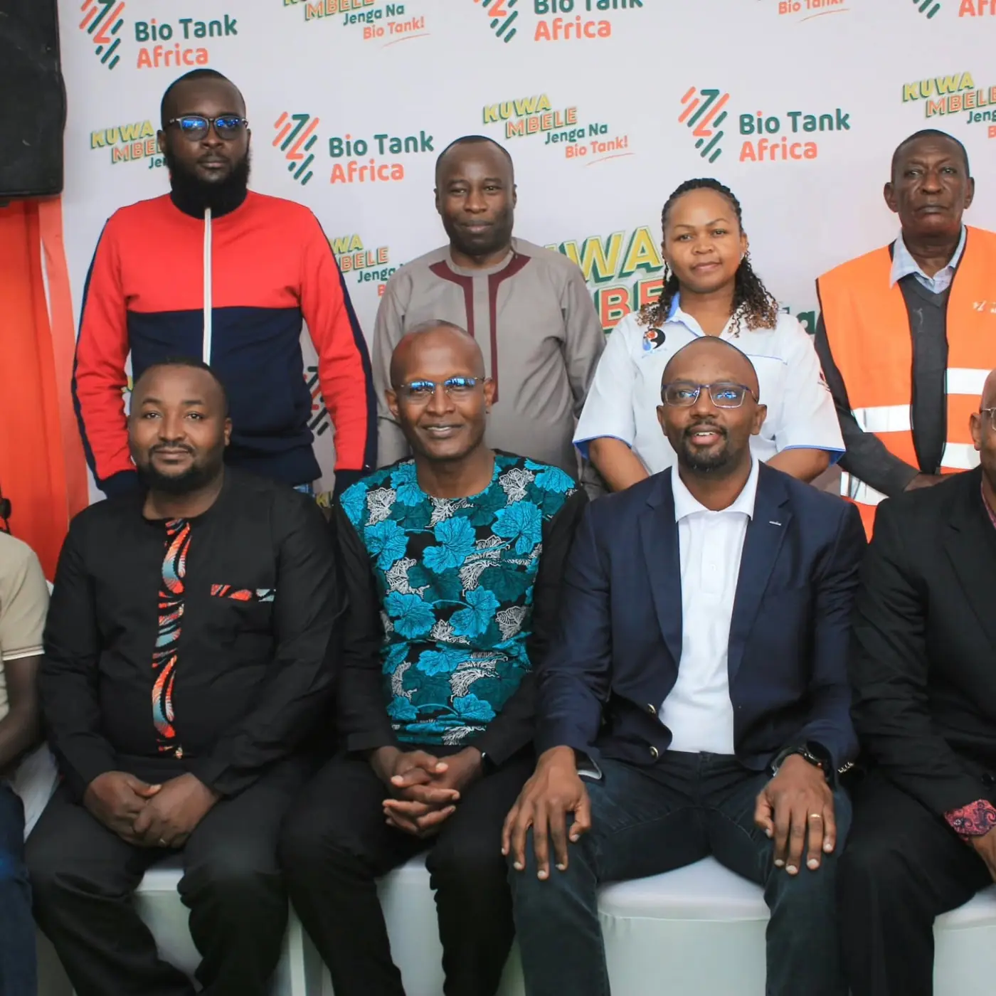 REBWAK and Bio Tank Africa representatives posing for a group photo in front of the Bio Tank Africa backdrop