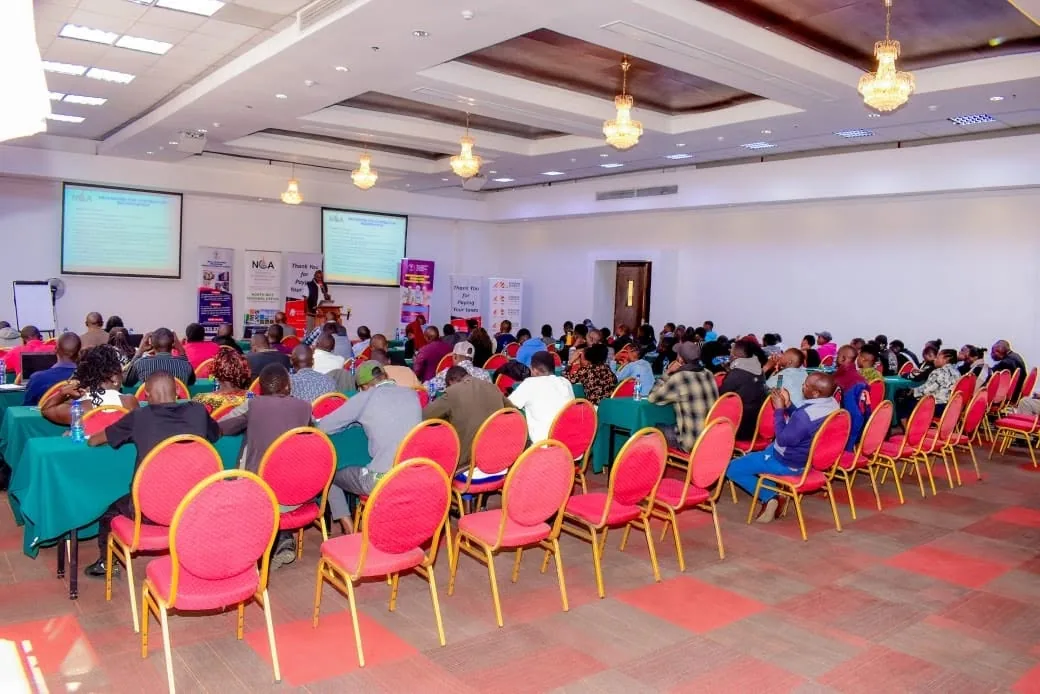 Participants following a presentation at the Eldoret forum