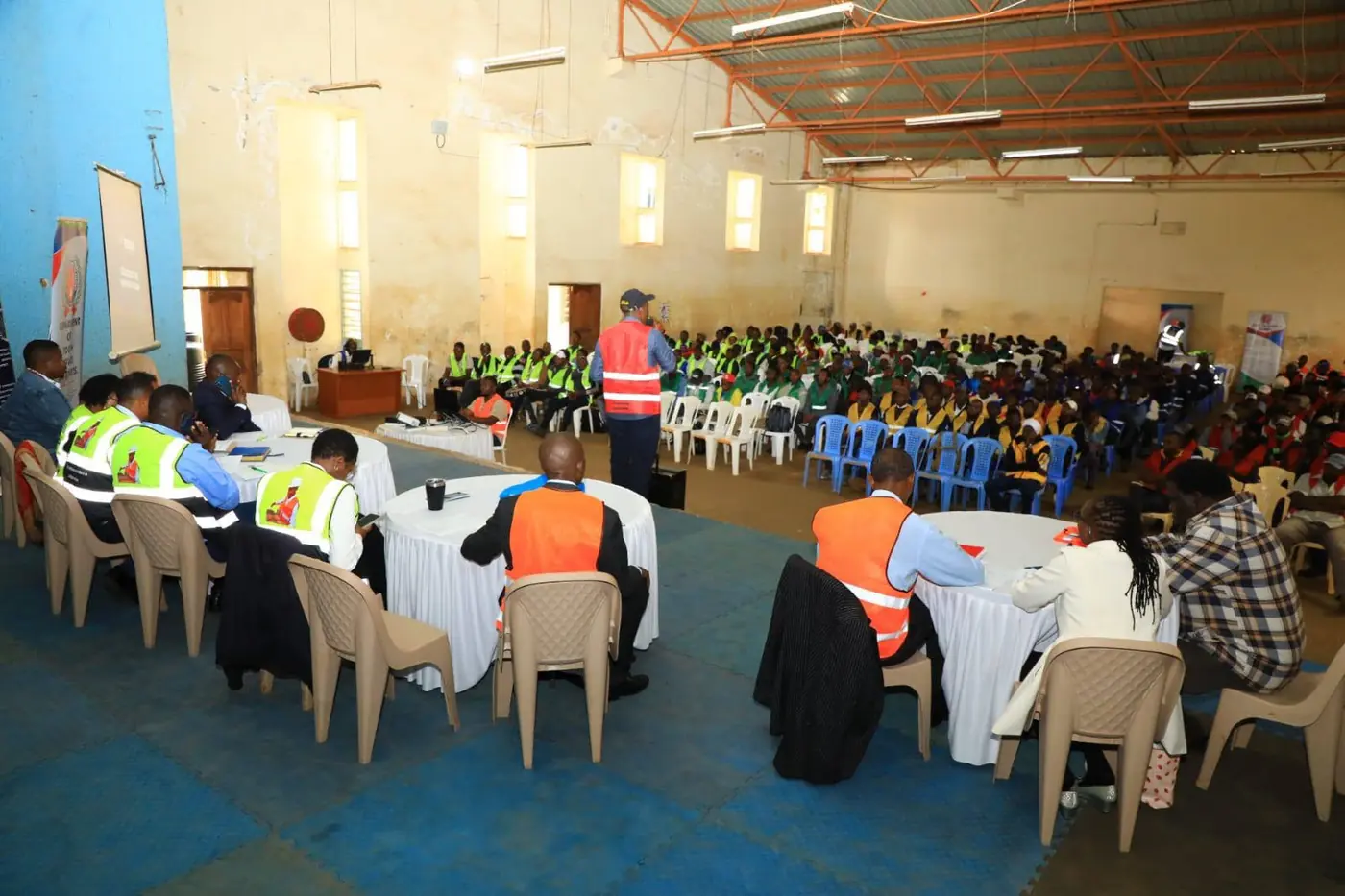 Wide view of the hall with officials at the front and participants seated
