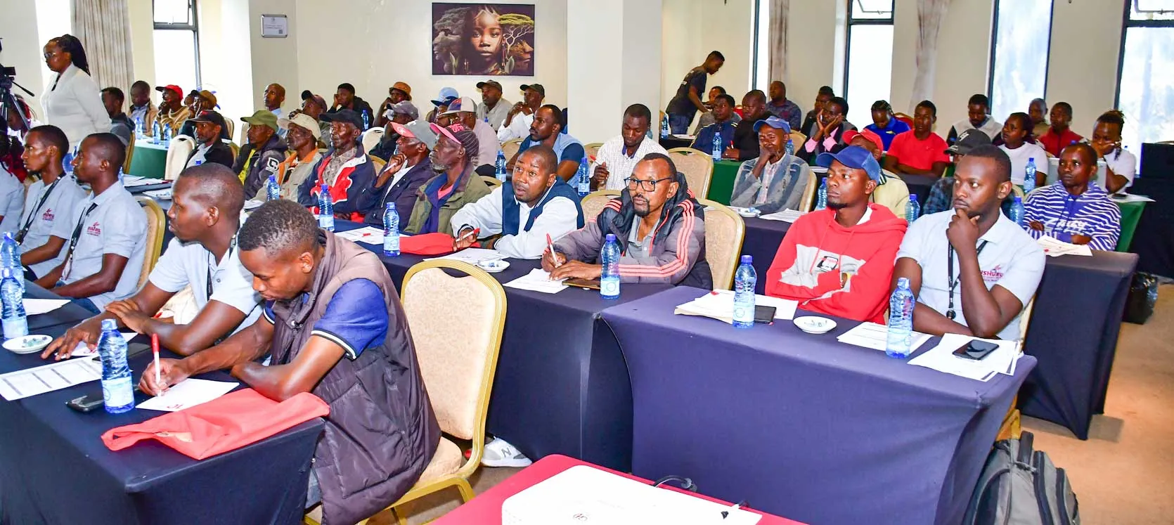 Construction workers taking notes at a REBWAK training forum