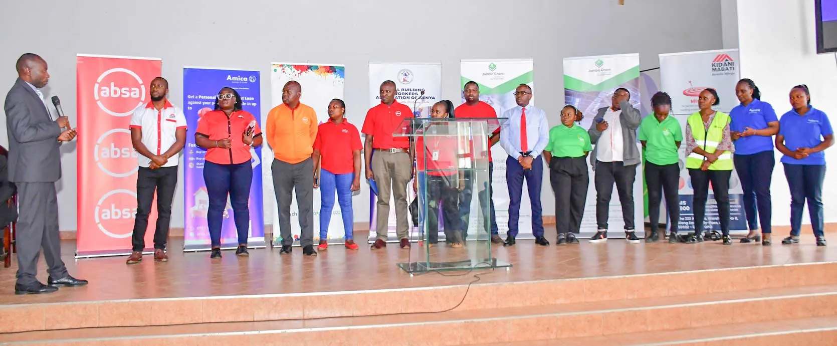 REBWAK members and partners standing together on stage at a forum