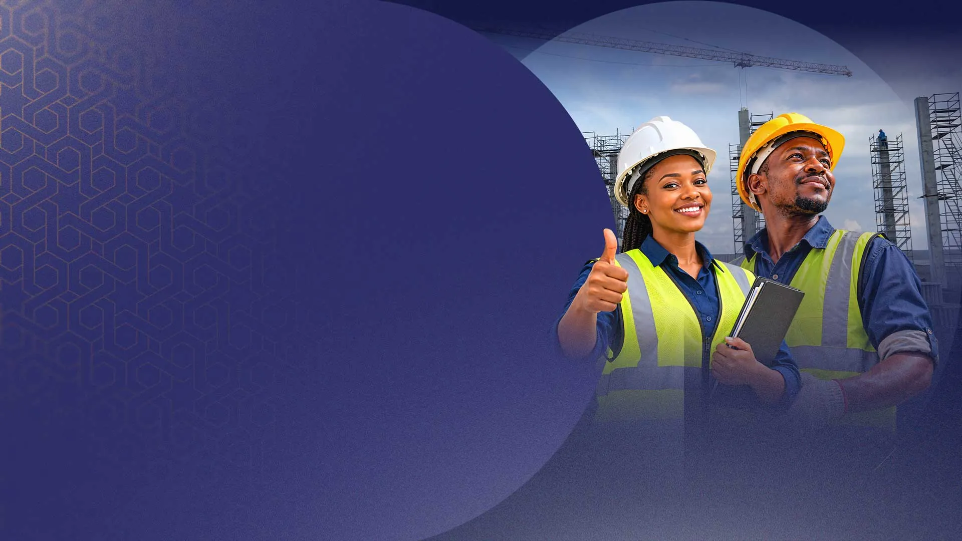 Two smiling REBWAK construction workers in hard hats and safety vests at a building site